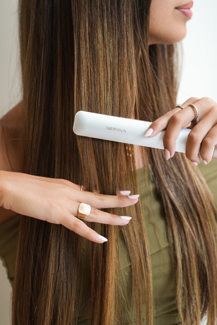 Woman styling hair with SIRINNA cordless straightener